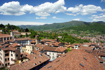 Fototapeta na wymiar The roofs of Bergamo. View of the Alps.