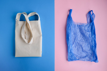 Plastic free concept. Cotton bag and plastic bag on pink and blue background. Flat lay