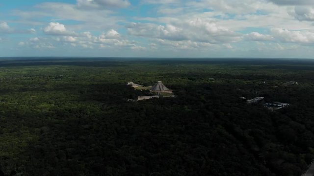Archeological site with excavated ruins of the large Maya city, including an iconic step pyramid