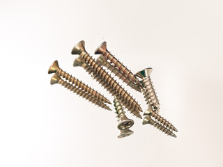 yellow hardware screws on a white background