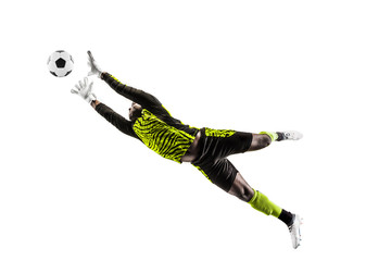 Male soccer player goalkeeper catching ball in jump. Silhouette of fit man with ball isolated on white studio background