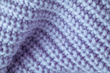 knitted jacket blue on white brick background