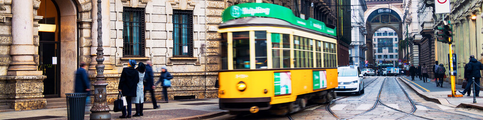 Fototapeta premium Yellow tram in the historical center of Milan, Italy