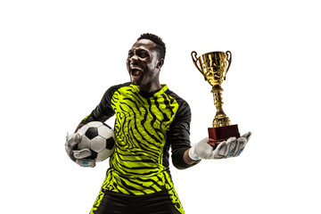 The celebrating soccer player with ball and cup isolated on white background. Competition winner...