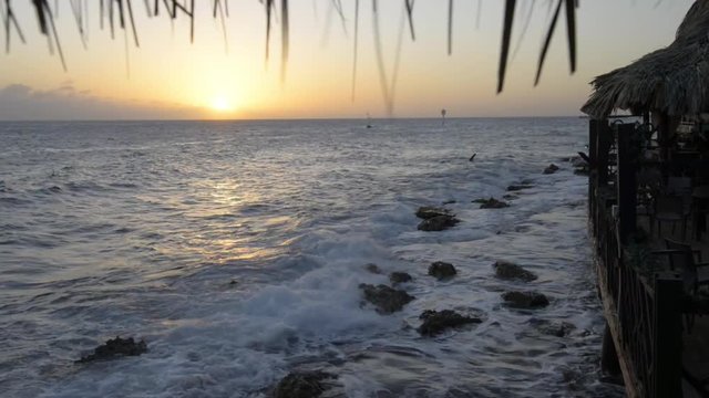 Sunset on the caribbean iseland Curacao. View out of a cafee.