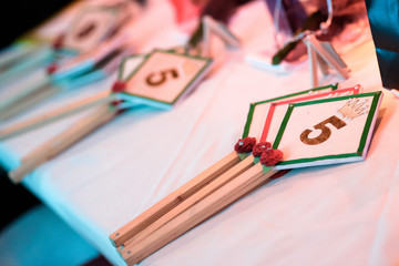 Scorecards on the jury's table during a beauty contest. Number 5 on the scorecards