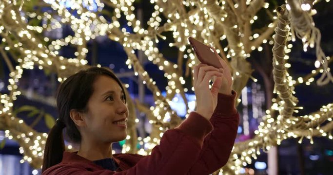 Woman take photo on the christmas decoration at outdoor