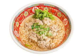 Close up of Instant noodle with meat ball and green Coriander on wood table.