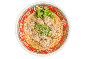 Close up of Instant noodle with meat ball and green Coriander on wood table.