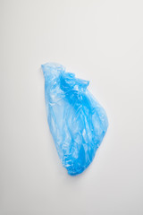 Fototapeta premium top view of blue garbage bag on white background