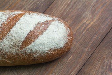 fresh grey bread on wooden background