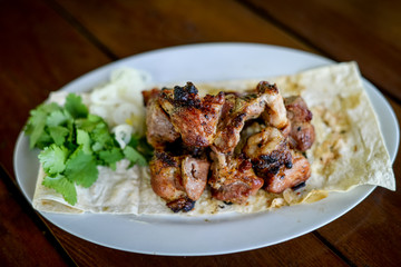 roasted meat on a grill in pita bread, shish kebab, close-up.