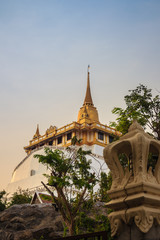 Fototapeta premium Beautiful view of Wat Saket Ratcha Wora Maha Wihan (Wat Phu Khao Thong, Golden Mount temple), a popular Bangkok tourist attraction and has become one of the symbols of the city.