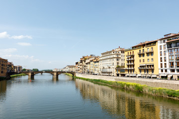 Fototapeta na wymiar Bridge across the Arno River, Florence, Italy with palazzos lining the bank