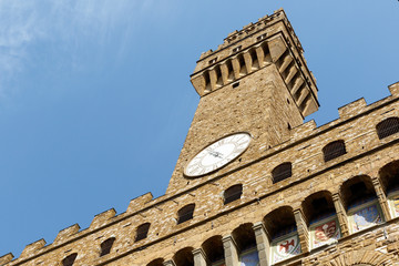 Color DSLR image of the historic landmark Tower of the Palazzo Vecchio, Florence, Italy, against a blue sky. Vertical with copy space for text