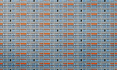 architectural pattern, window facade with orange shutters of a skyscraper