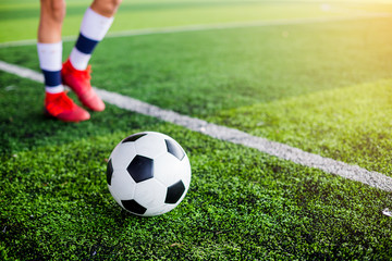 football on green artificial turf with soccer player speed run