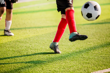 Obraz premium Soccer player speed run to shoot ball to goal on artificial turf