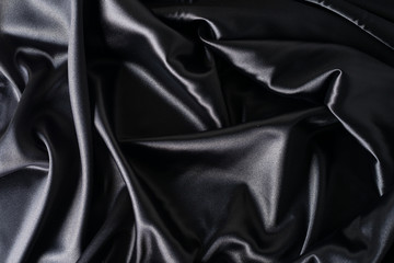 texture, background, pattern. Black silk fabric. Transform its tougher drape into a design for any event. It is a crispy, lightly textured hand