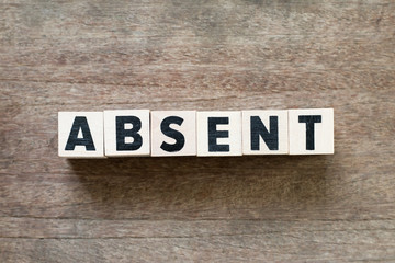 Letter block in word absent on wood background