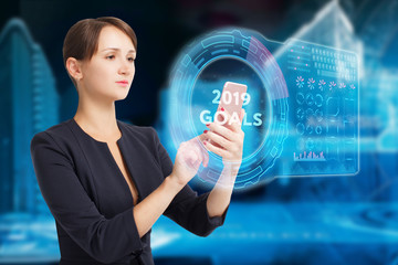 The concept of business, technology, the Internet and the network. A young entrepreneur working on a virtual screen of the future and sees the inscription: 2019 goals