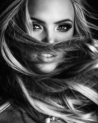 blond lady with beautiful hair on grey