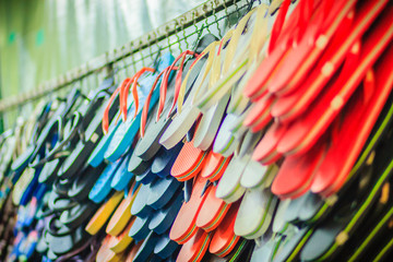 Colorful flip flop sandals in store at Khao San Road night market, Bangkok, Thailand.