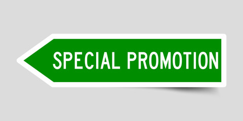 Sticker in green color arrow shape with word special promotion on gray background