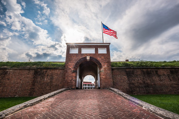 Historic American flying over the entrance to Fort McHenry National Monument, Baltimore, Maryland - obrazy, fototapety, plakaty