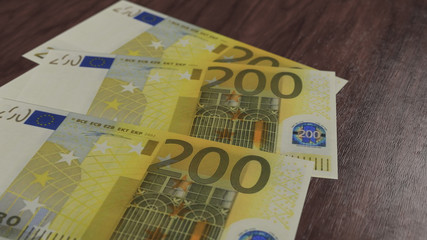 Banknote fan of two hundred euro on the wooden floor. 200 european cash currency 3D illustration, depth of field.