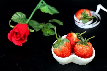 fresh red strawberry on black