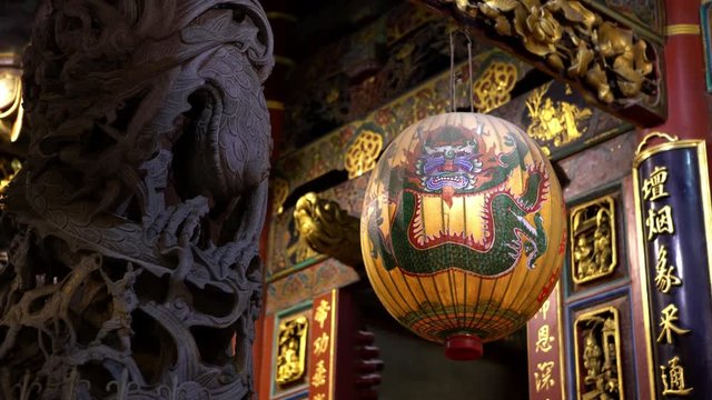 4K, Beautiful traditional Chinese lantern hangs with an aged carved and painted wooden in Taiwan first temple of heaven. Dragon lanterns decoration. God of Jade Emperor, deities in Taoist faith-Dan