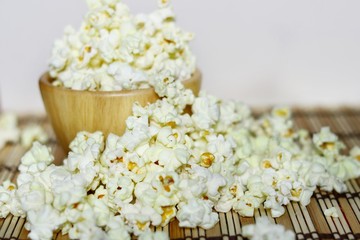 Close up, Butter popcorn in the wooden bowl and around, Selective focus