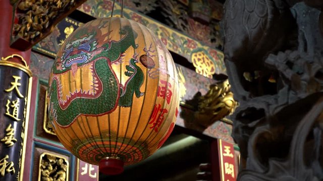 4K, Beautiful traditional Chinese lantern hangs with an aged carved and painted wooden in Taiwan first temple of heaven. Dragon lanterns decoration. God of Jade Emperor, deities in Taoist faith-Dan