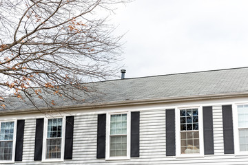 Front closeup of house during day in winter with bare oak tree and windows with gray color Single Family Home in Virginia