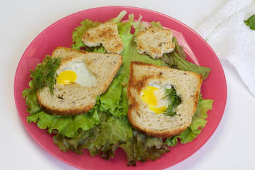 Breakfast of sausages, quail eggs, herbs and vegetables.
