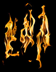 three bright sparks of yellow flames on black