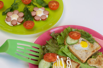 Breakfast of sausages, quail eggs, herbs and vegetables.