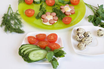 Breakfast of sausages, quail eggs, herbs and vegetables.