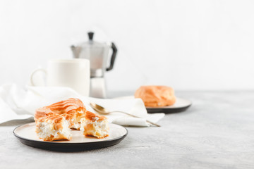 Cream puff rings - choux pastry, and cup of black coffee