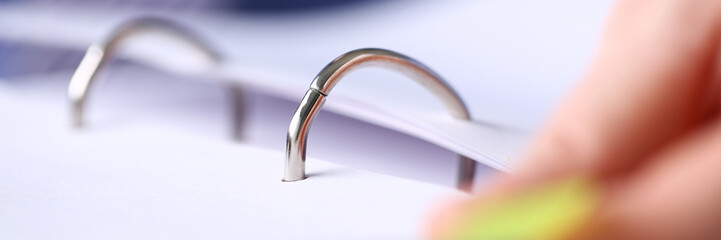File binder fastener with pile of papers clipped inside