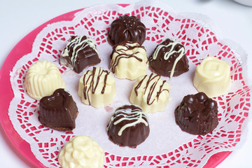 Cooking sweets with coconut and condensed milk. In a glaze of white and black chocolate.