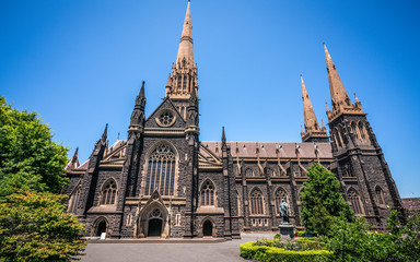 Fototapeta na wymiar Side view of St Patrick's Cathedral and spire a Roman Catholic Cathedral church in Melbourne Vic Australia