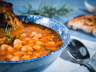 Chickpea soup, vegan, vegetarian. Italian traditional dish served in a bowl with bread and...