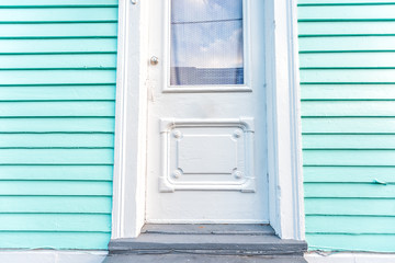 New Orleans, USA Old town Royal street in Louisiana famous town city and closeup of turquoise blue green colorful door wall on building home