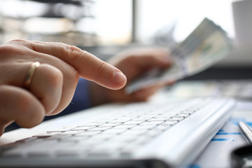 Male arms hold credit card press buttons making transfer