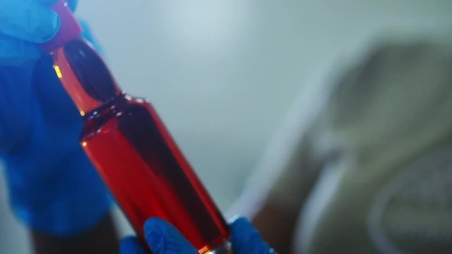 Scientist inspecting the sustainable biodiesel macauba palm oil in the factory.