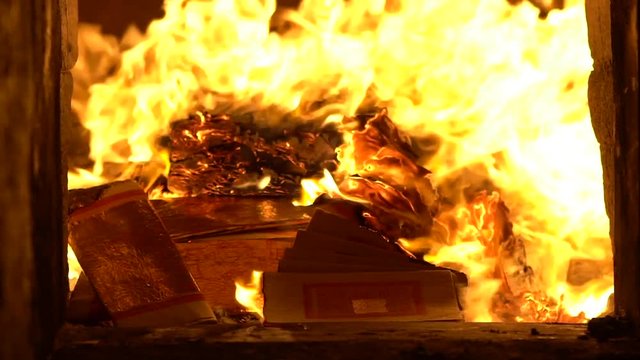 Slow Motion of people burning joss paper in ancient asian temple Taiwan. Temples are a place of worship. Taiwanese folk religion for make wish. People praying buddha with incenses sticks-Dan