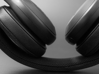 wireless black headphones on a dark background.