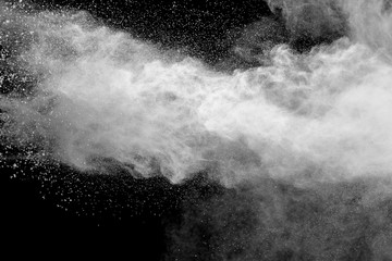 White talcume powder explosion on black background. White dust splashing.